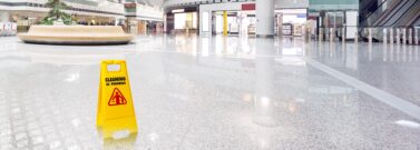 Slippery floor with warning in shopping centre to help avoid accidents and public liability claims