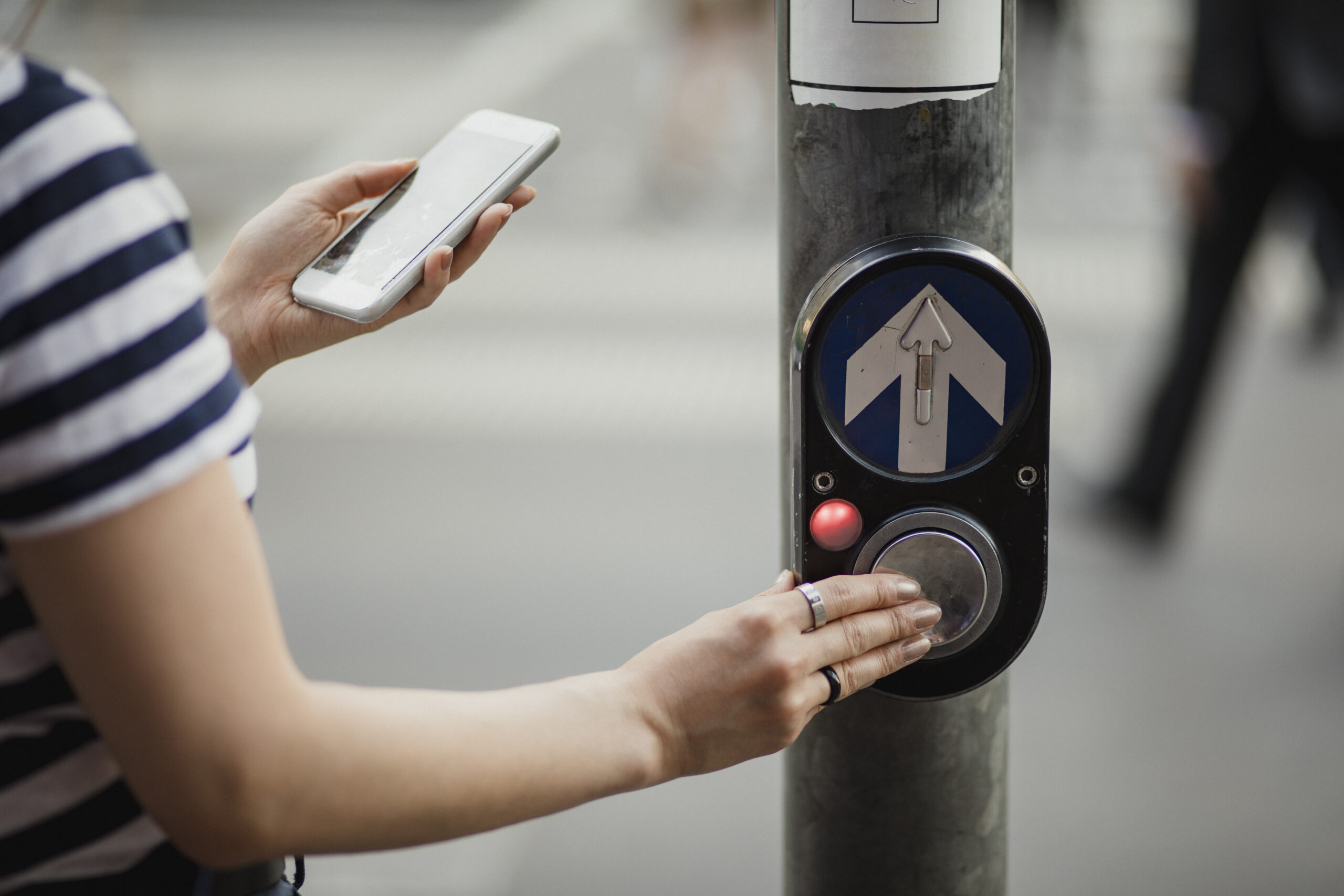 Pedestrian at Road Crossing Looking at Phone