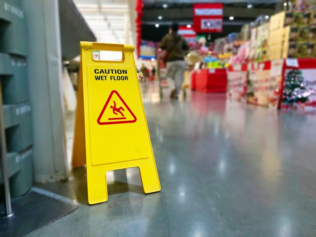 Caution Wet Floor Sign in Shopping Centre - Slip, Trip and Fall Accidents