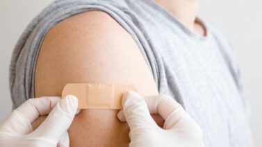 Man with a band-aid after receiving the Covid-19 vaccine