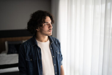 Young man contemplating at home